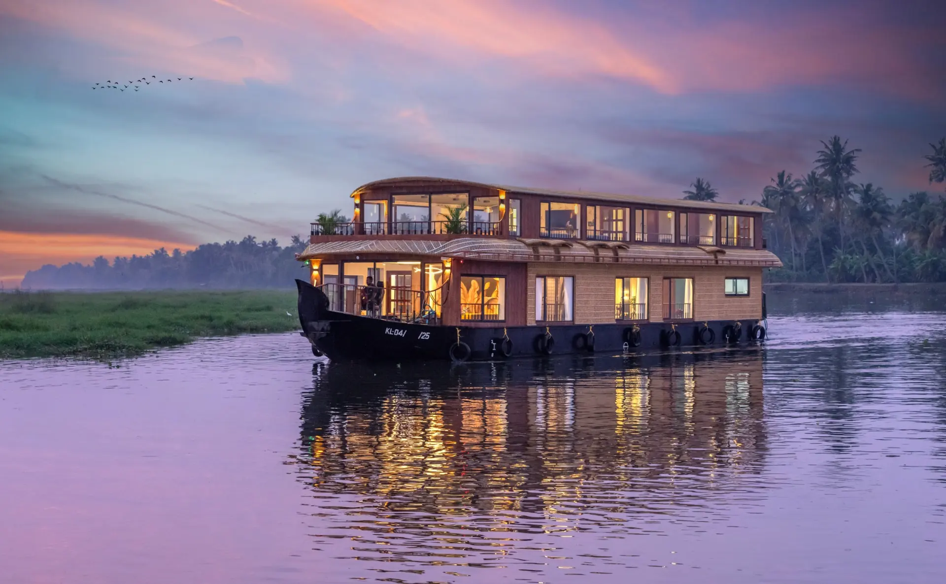 Alleppey houseboat evening cruise with warm lights